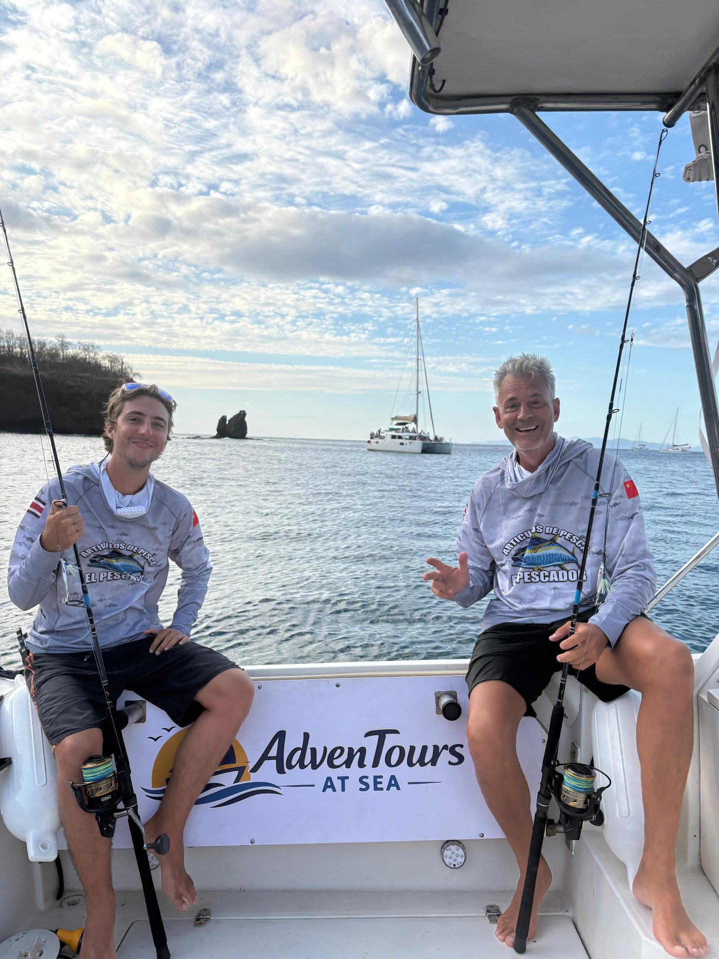 Guests fishing aboard Adventours at Sea with the boat logo in view