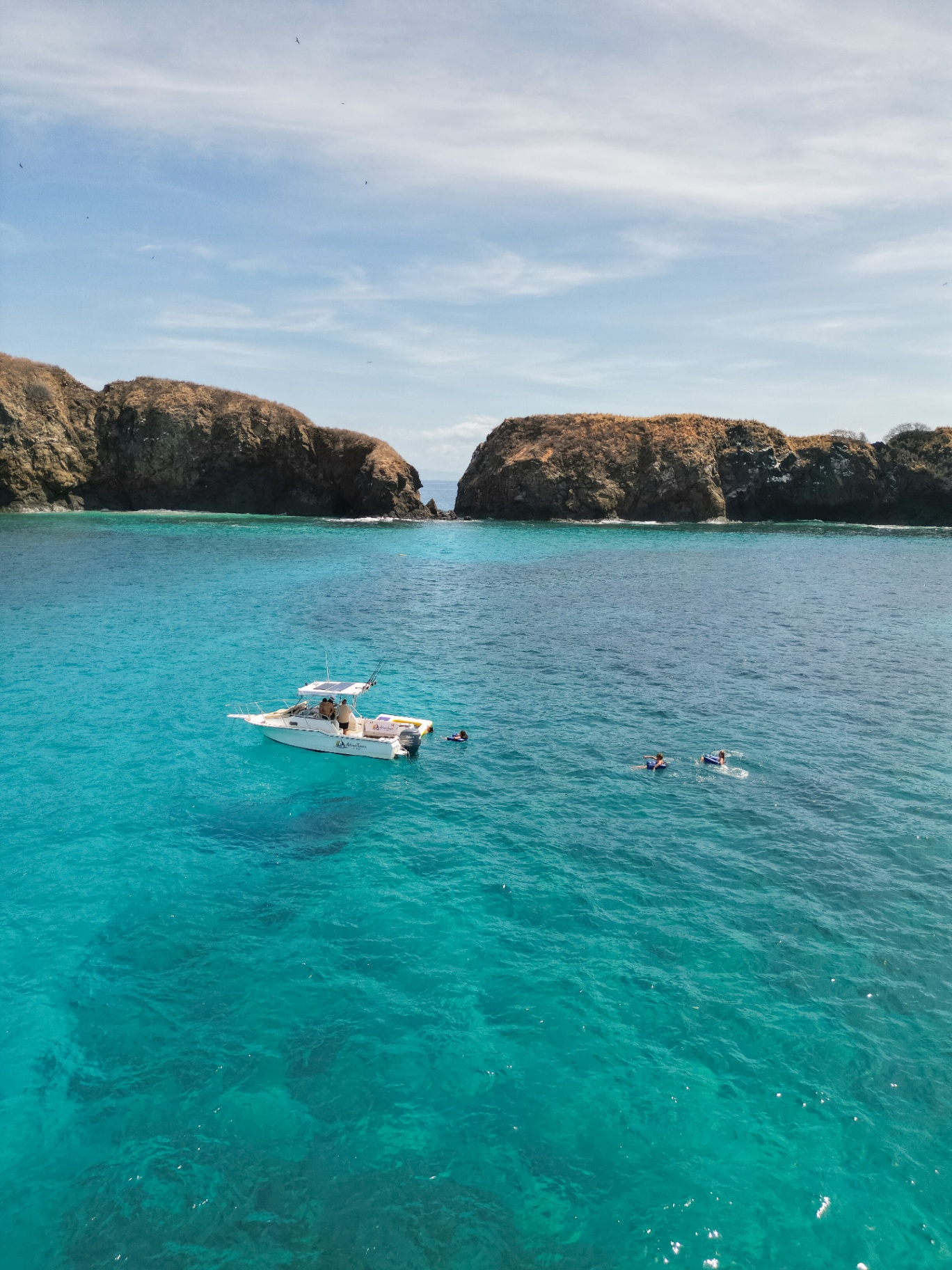 Adventours at Sea and swimmers in a turquoise cove off Guanacaste