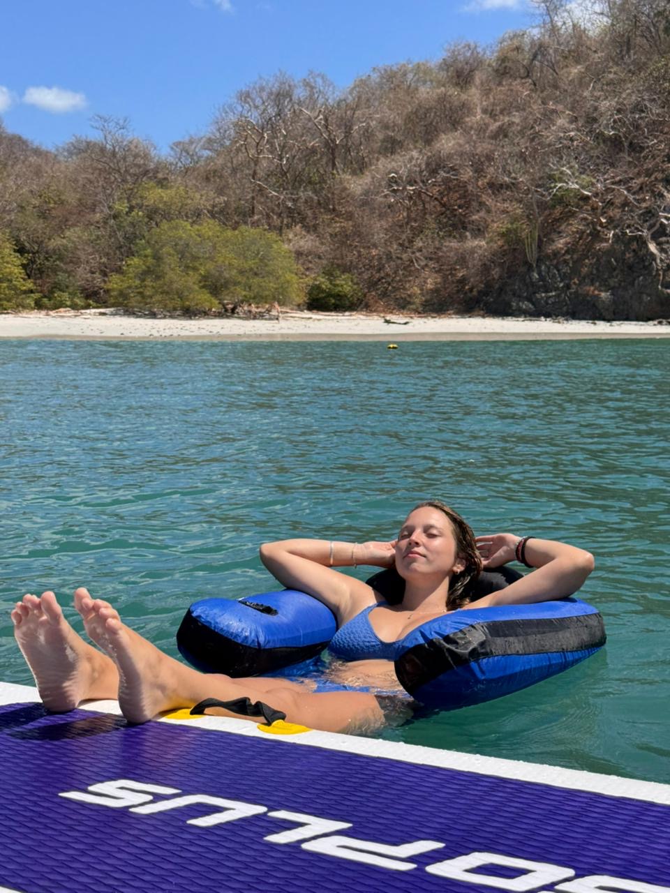 Guest floating beside the boat on a private snorkel day from Flamingo