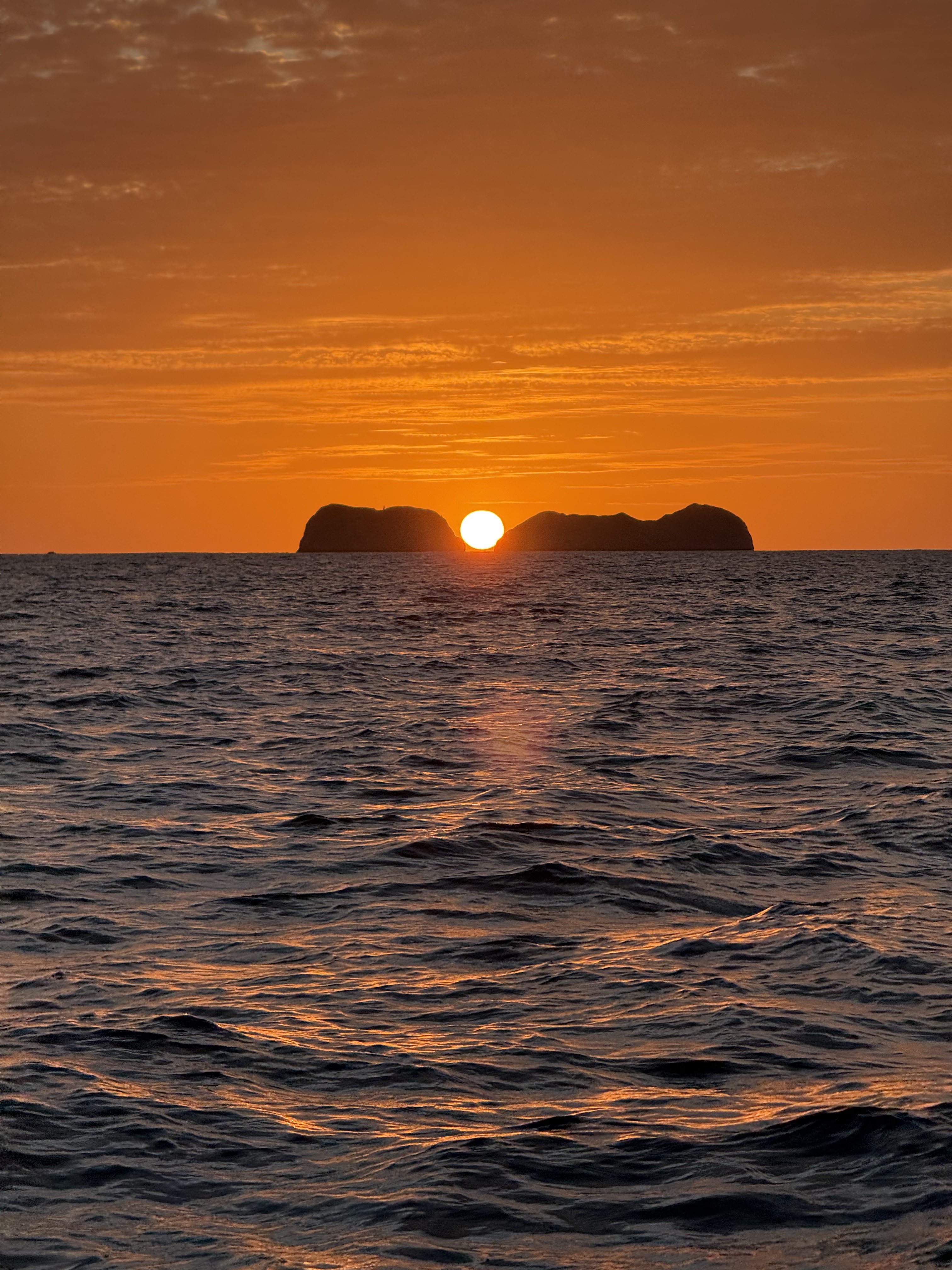Sun setting between the Catalina Islands on a private cruise from Flamingo, Guanacaste